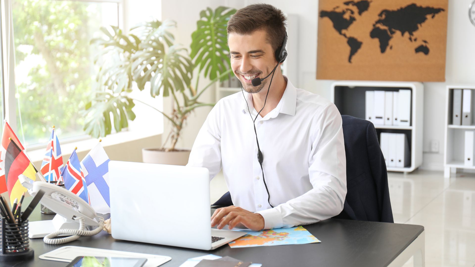 Happy young man on phone in office